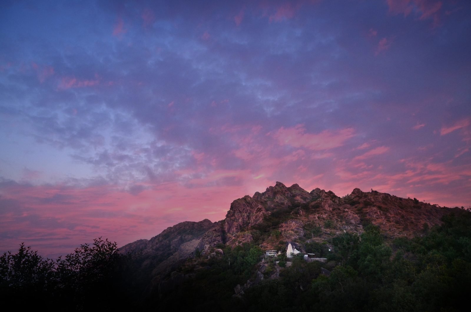 Vivid sunset glow over the rugged mountain peaks and valley from Sunset Point, Mount Abu